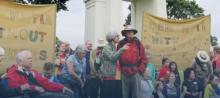 group of old people in a rally with a sign saying "dementia without boarders"